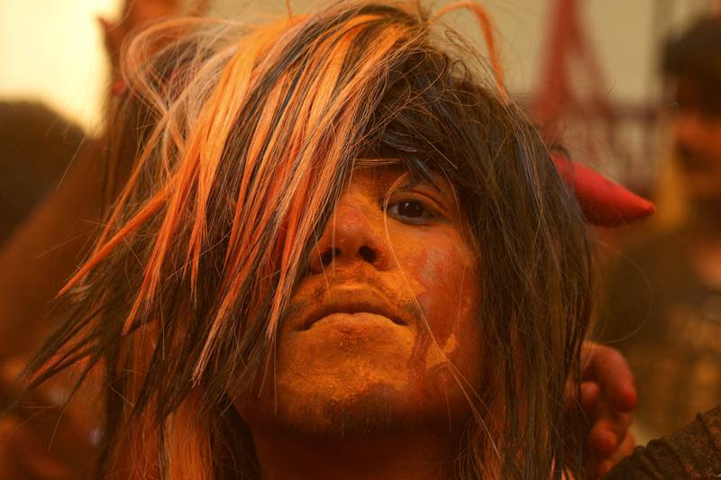 A reveller smeared with coloured powder, in Hyderabad. AP