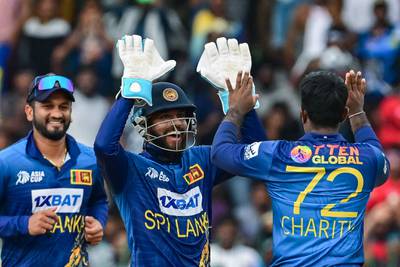 Sri Lanka's Charith Asalanka celebrates with teammates after taking the wicket of India's Ishan Kishan. AFP