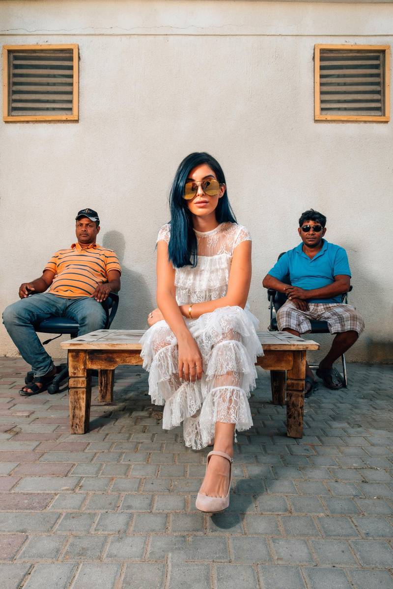 <p>An influencer&rsquo;s photoshoot in Satwa in which a scantly clad-model poses with Satwa men in the background has caused controversy and debate. Photo Courtesy Waleed Shah</p>
