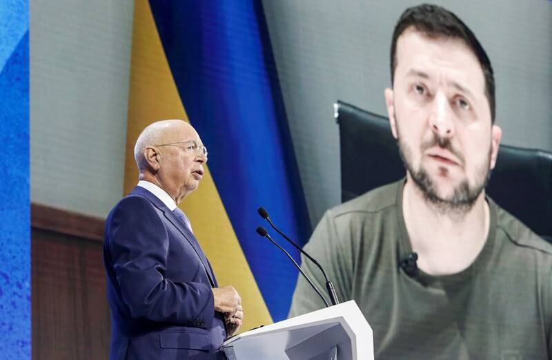Founder and Executive chairman Klaus Schwab addresses the delegates with the Ukraine's President Volodymyr Zelenskiy displayed on a screen in the background during the opening ceremony of the World Economic Forum (WEF) in Davos, Switzerland on May 23. Reuters