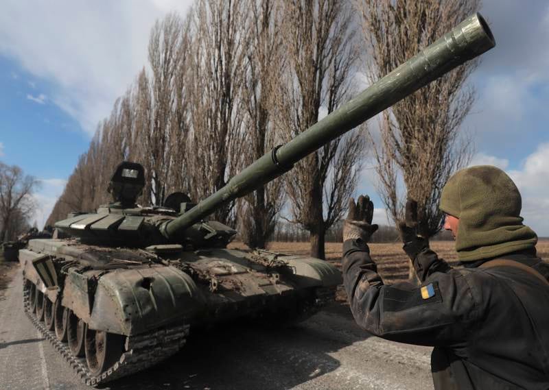A Ukrainian serviceman with a captured Russian tank in the village of Lukyanivka, near Kyiv. EPA