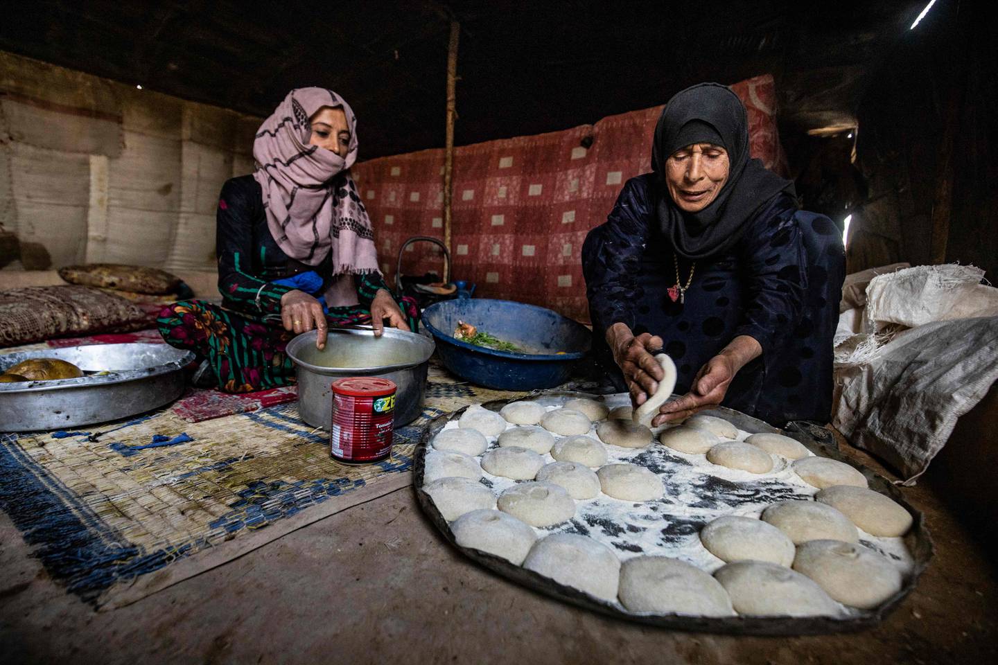 Two Syrian women prepare Ramadan food at the Kabsh camp for displaced people in the countryside near Syria's northern city of Raqqa. AFP