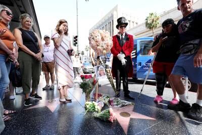 Fans stop by late actress  Olivia Newton-John's star on Hollywood Walk of Fame, which is adorned with flowers and photographs. Reuters