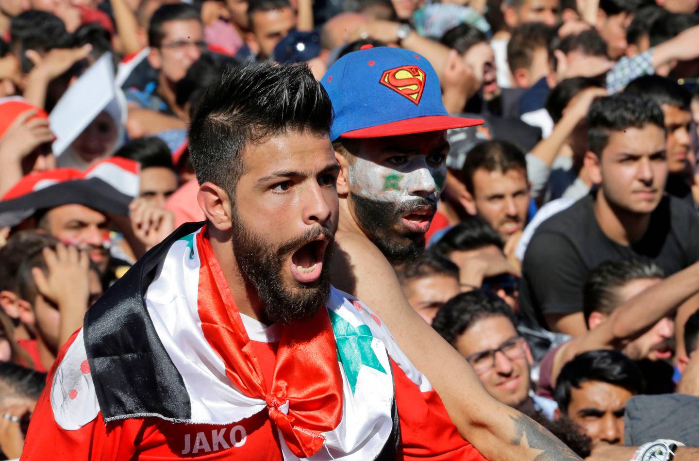 Syrians cheer on their national team at the Umayyad Square in Damascus as they watch a live broadcast of the World Cup 2018 qualifying play-off football match between Syria and Australia on October 10, 2017.
Australia's veteran striker Tim Cahill scored deep into extra time to take Australia a big step closer to next year's World Cup and end war-torn Syria's fairytale run in the play-offs. / AFP PHOTO / LOUAI BESHARA