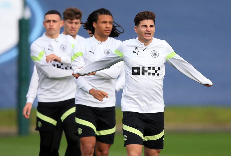 Phil Foden, left, Nathan Ake, centre, and Julian Alvarez attend a team training session at Etihad Campus. AFP