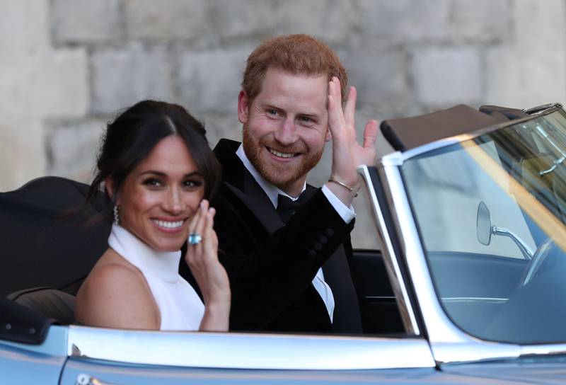 WINDSOR, UNITED KINGDOM - MAY 19: Duchess of Sussex and Prince Harry, Duke of Sussex wave as they leave Windsor Castle after their wedding to attend an evening reception at Frogmore House, hosted by the Prince of Wales on May 19, 2018 in Windsor, England. (Photo by Steve Parsons - WPA Pool/Getty Images)