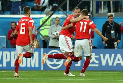 Soccer Football - World Cup - Group A - Russia vs Egypt - Saint Petersburg Stadium, Saint Petersburg, Russia - June 19, 2018   Russia's Roman Zobnin celebrates with Artem Dzyuba and Denis Cheryshev after Egypt's Ahmed Fathy scored an own goal and the first goal for Russia      REUTERS/Pilar Olivares