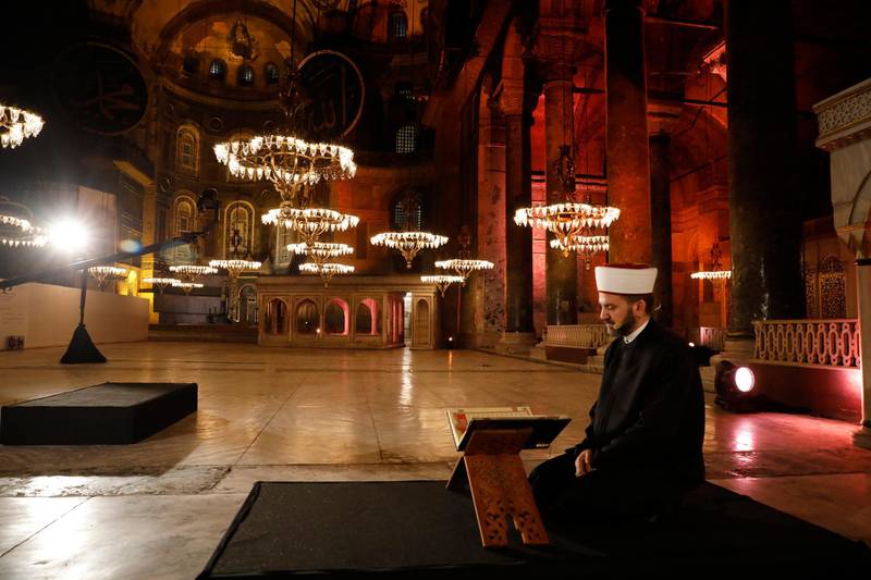 An imam recites the Quran inside Istanbul's 6th-century Hagia Sophia museum. Turkey’s top administrative court announced its decision to revoke the 1,500-year-old former cathedral’s status as a museum. AP Photo