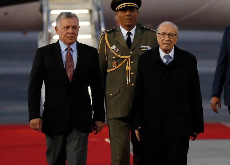 King Abdullah II of Jordan, left, walks next of Tunisian President Beji Caid Essebsi, right, as they review the honor guard upon his arrival. AP Photo