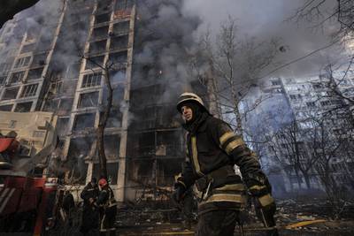 A firefighter outside a destroyed apartment building in a residential area of Kyiv. AP
