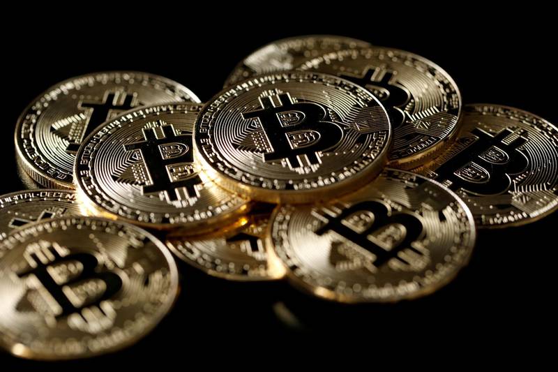 FILE PHOTO: A collection of Bitcoin (virtual currency) tokens are displayed in this picture illustration taken December 8, 2017. REUTERS/Benoit Tessier/File Photo
