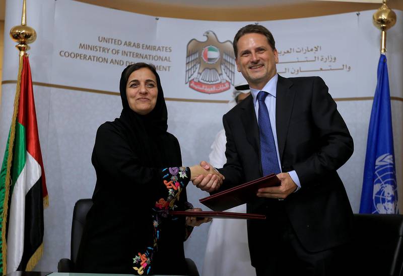 ABU DHABI - UNITED ARAB EMIRATES - 21JULY2014 - Shaikha Lubna Bint Khalid Al Qasimi, Minister of International Cooperation & Development and Head of the National Committee for the Coordination of Foreign Aid and Pierre Krahenbuhl, Commissioner General of UNRWA, shake hands after signing an agreement in which UAE is providing the UNRWA with AED 55 million for the benefit of 361,300 Palestinian victims, representing 92,200 displaced Palestinian families inside Syria, in the presences of Mohamed Saif Al Suwaidi (behind left) the Director General of Abu Dhabi Fund for Development and Hazza Mohamed Al Qahtani, MICAD's Undersecretary yesterday at Ministry of International Cooperation and Development office in Abu Dhabi. Ravindranath K / The National (to go with Anwar story for News)