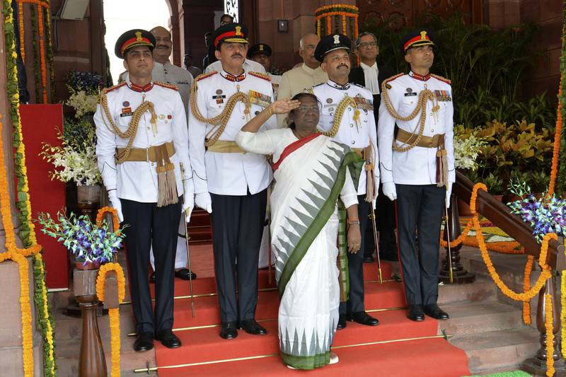Ms Murmu salutes troops during her swearing-in ceremony in New Delhi. AP