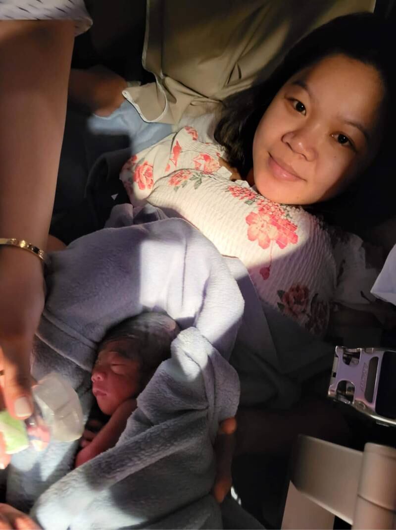 Sheryl Frigillana and her baby, after giving birth on Flight KU417, helped by medical professionals on board.