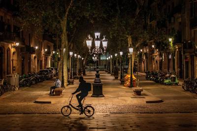 A man rides his bike along the empty Passeig del Born avenue during a curfew in Barcelona, Spain. EPA