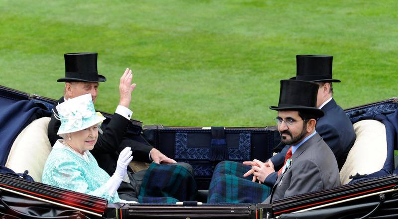 Britain's Queen Elizabeth II (2nd L) and her husband The Duke of Edinburgh (L) sit opposite Mohammed bin Rashid Al Maktoum (2nd R) as they arrive for the days' racing during Ladies Day, the third day of Royal Ascot, in Berkshire, west of London, on June 18, 2009. The five-day meeting is one of the highlights of the horse racing calendar. Horse racing has been held at the famous Berkshire course since 1711 and tradition is a hallmark of the meeting. Top hats and tails remain compulsory in parts of the course while a daily procession of horse-drawn carriages brings the Queen to the course. AFP PHOTO/Adrian Dennis (Photo by ADRIAN DENNIS / AFP)