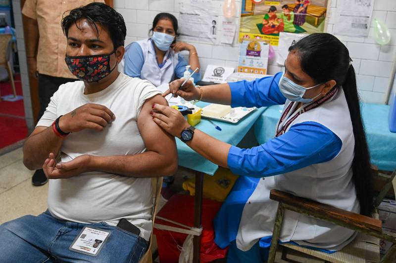 A health worker inoculates a man with a dose of the Covaxin vaccine in New Delhi. Prakash Singh/ AFP