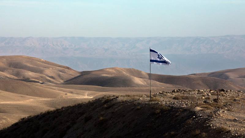 epa07195160 An Israeli flag flies on a hill outside the Jewish settlement of Kfar Adumim in the West Bank, south of Jerusalem and overlooking the Jordan Valley, 28 November 2018.  EPA/JIM HOLLANDER