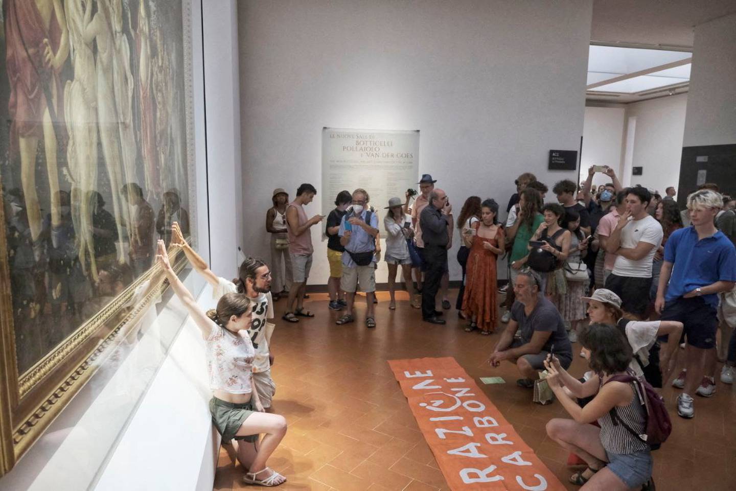Protesters glue themselves to Botticelli's 'Primavera' in the Uffizi Gallery, in Florence, Italy. Photo: Reuters