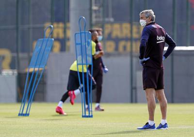 Barcelona's Spanish coach Quique Setien wearing a face mask as he takes  training