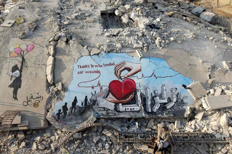A mural painted on the rubble of a building that collapsed in the rebel-held town Jindayris. AFP