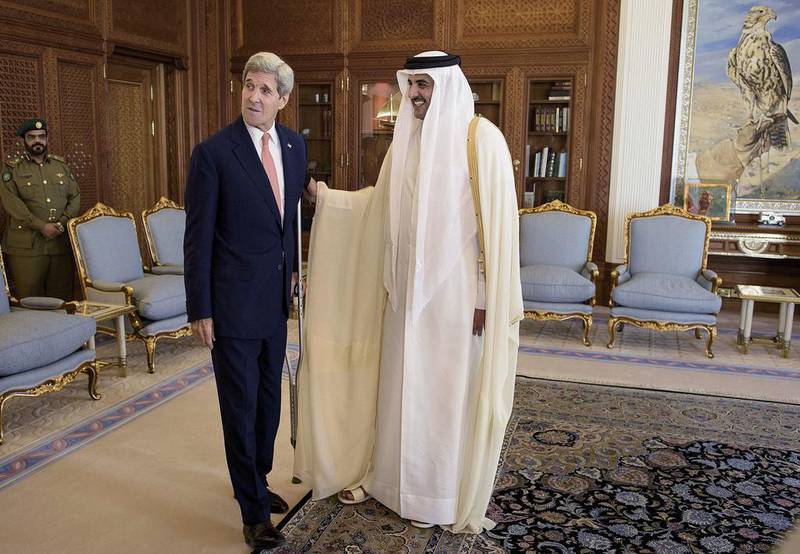 John Kerry, the US Secretary of State, left, talks with Qatar's Emir Sheikh Tamim bin Hamad Al Thani before a meeting at the Diwan Palace in Doha. Brendan Smialowski / AFP Photo