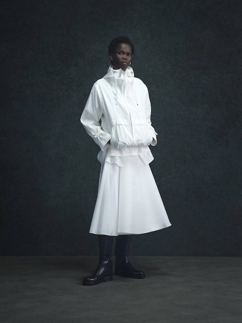 A sporty anorak is given a lift in white and worn over a bias cut full skirt.