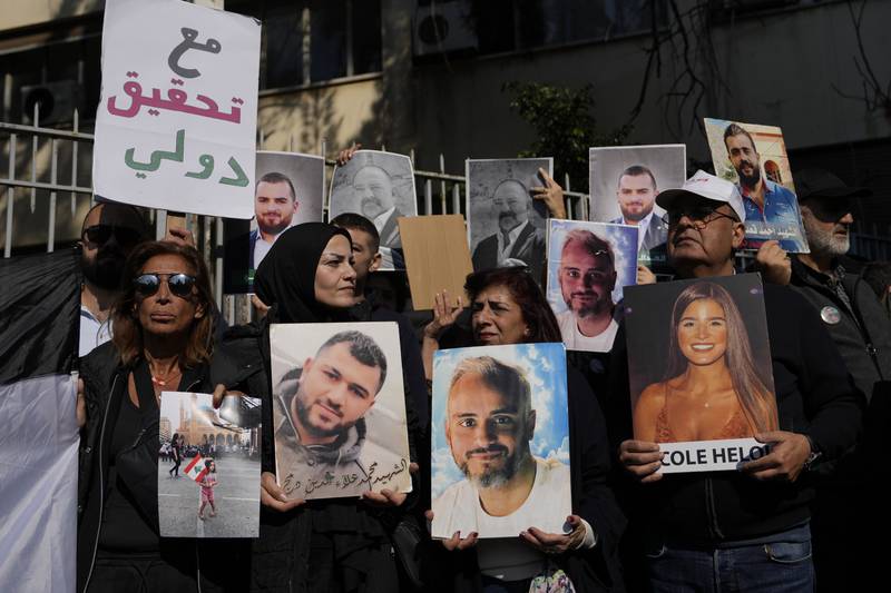 Relatives of victims of the 2020 Beirut port explosion hold portraits of loved ones during a protest in front of the Justice Palace in Lebanon’s capital. AP