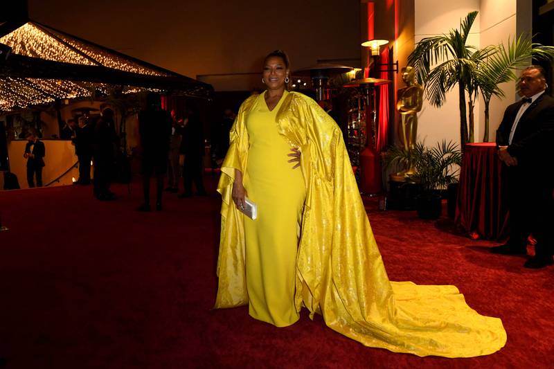 Queen Latifa, wearing yellow Pamella Roland. AFP