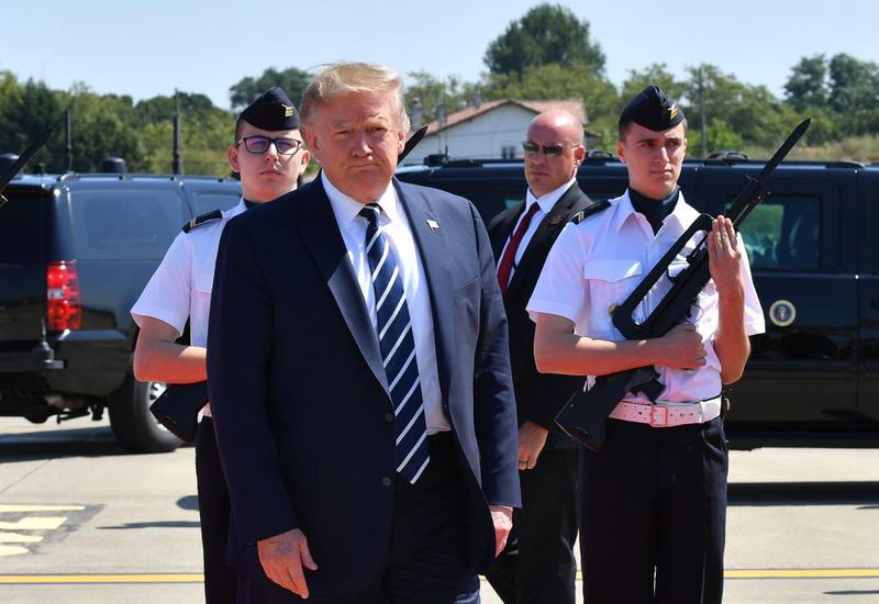 US President Donald Trump walks past French airforce soldiers after disembarking from an airplane upon landing at the Biarritz Pays Basque Airport in Biarritz, south-west France on the first day of the annual G7 Summit. AFP