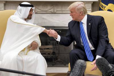 US President Donald Trump shakes hands with Crown Prince Mohammed Bin Zayed Al Nahyan of Abu Dhabi during a meeting in the Oval Office of the White House in Washington, DC, May 15, 2017. (Photo by SAUL LOEB / AFP)