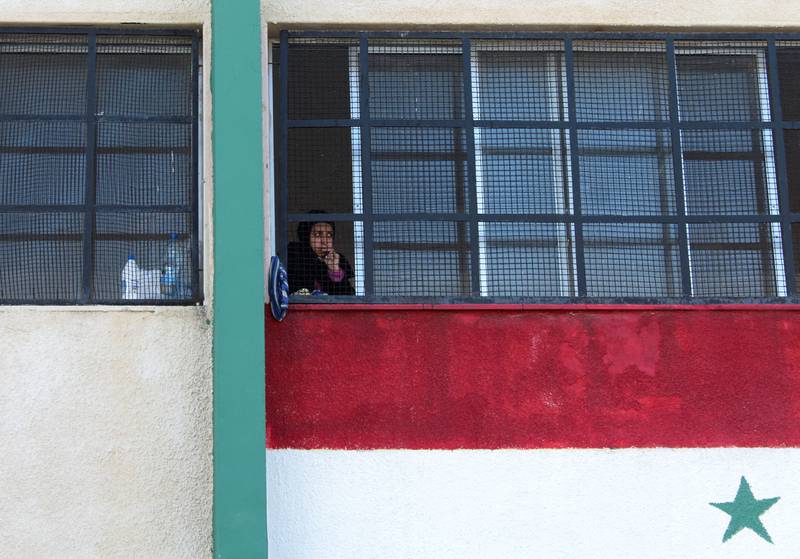 A woman looks out from a school-turned-shelter for families affected by the deadly earthquake in Latakia, Syria on Thursday. Reuters 