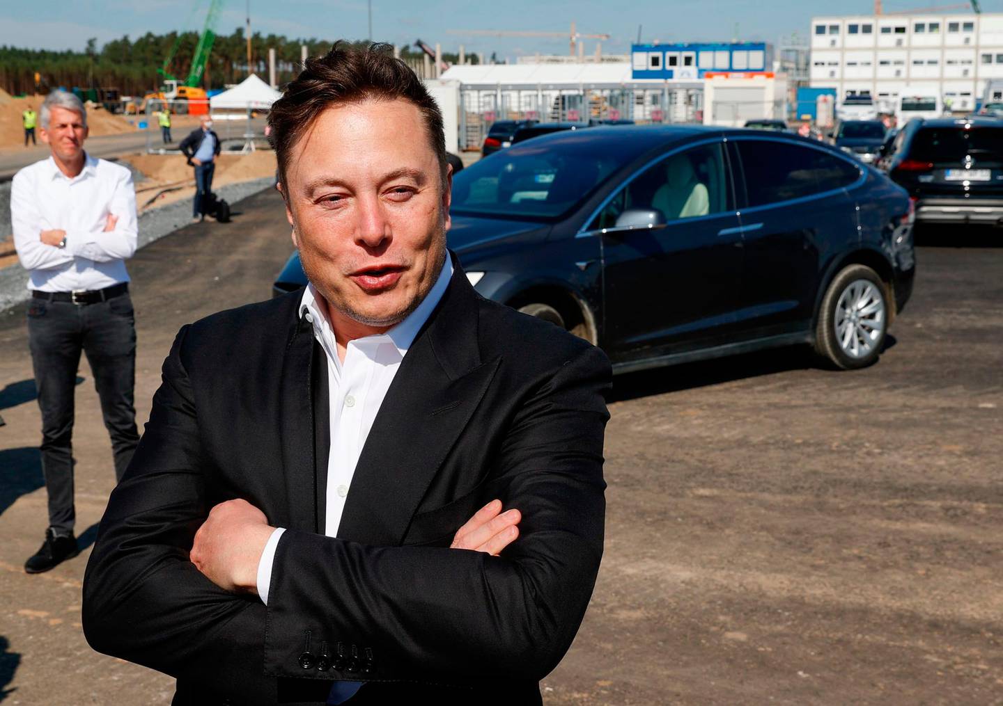 FILES) In this file photo Tesla CEO Elon Musk talks to media as he arrives to visit the construction site of the future US electric car giant Tesla in Gruenheide near Berlin on September 3, 2020. Tesla delivered a record number of cars in 2020, the company said, just narrowly missing its half a million target for the year. The pioneering high-end electric vehicle maker delivered 180,570 cars to customers and produced 179,757 in the fourth quarter of the year, it said in a statement on January 2, 2021.

 / AFP / Odd ANDERSEN
