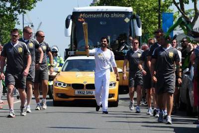 General Manager of Easa Saleh Al Gurg Group Adbulla Al Gurg of Dubai carries the Olympic torch through London on Thursday, July 26, 2012. (Photo courtesy Alex Broadway)