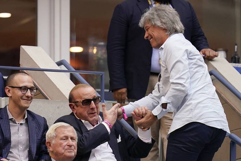 Jon Bon Jovi, right, greets music producer Clive Davis at the US Open in New York on Friday. AP