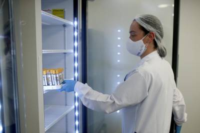 An employee puts some samples taken to detect the coronavirus disease (Covid-19) inside a refrigerator of the Synlab laboratory at the El Dorado airport in Bogota, Colombia. Reuters