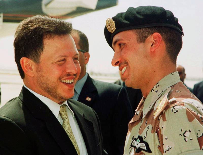 Jordan’s King Abdullah II laughs with his half brother Prince Hamzah, right, shortly before the monarch embarked on a tour of the United States. AP, file