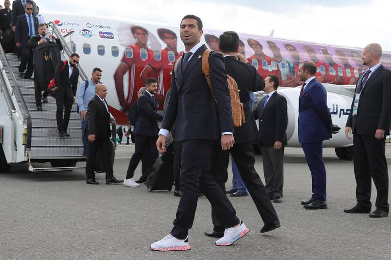Egyptian national team football player Ahmed Fathi arrives at Grozny International Airport  rocking a leather backpack with two-tone sneakers and a formal suit. Confident. AFP