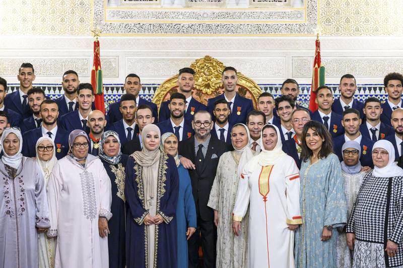 King Mohammed with the country's football team and their relatives at the royal palace. AFP