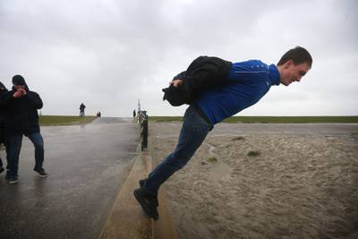 A man stand on the edge of a seawall during Storm Ciara in Harlingen which has brought unusually high winds across Europe with many countries cancelling national and international sport events.   AFP
