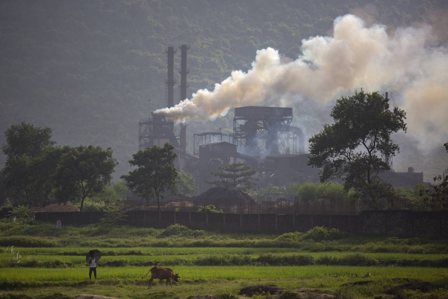 Smoke rises from a steel plant near Ranchi in Jharkhand state that is powered by coal, a fuel source India has pledged to turn away from under its commitments to curb climate change. AP