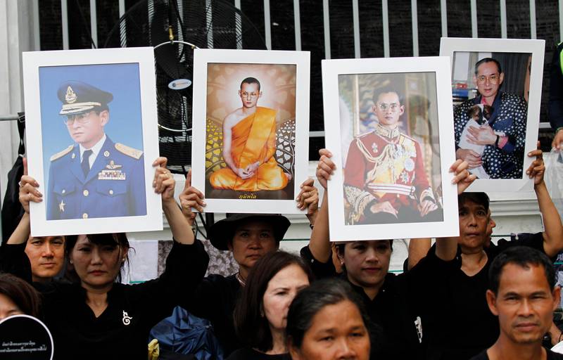 Thai mourners hold up portraits of the late King Bhumibol Adulyadej near Grand Palace to take part in the Royal Cremation ceremony in Bangkok, Thailand. Sakchai Lalit / AP Photo