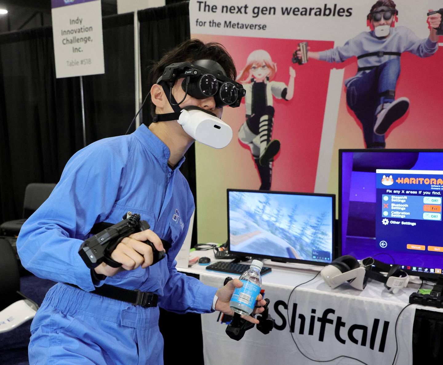 A user demonstrates Shiftall's full-body tracking device, including the mutalk bluetooth microphone over his mouth and FlipVR controllers, for playing VR in the metaverse during a press event at CES 2023. Getty