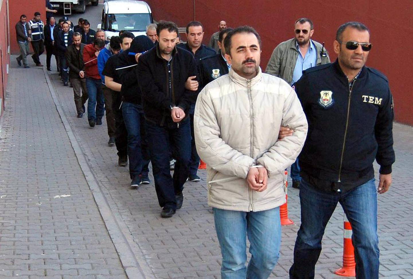 Turkish police escort suspects of the Gulen movement in the Turkish city of Kayseri in 2017, months after a failed coup attempt. EPA