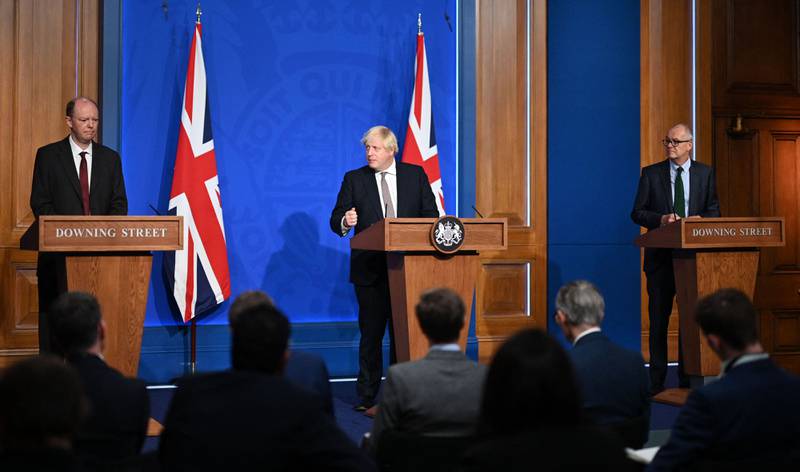 Britain's Prime Minister Boris Johnson (C), Britain's Chief Medical Officer for England Chris Whitty (L) and Britain's Chief Scientific Adviser Patrick Vallance attend a media briefing at Downing Street. AFP.