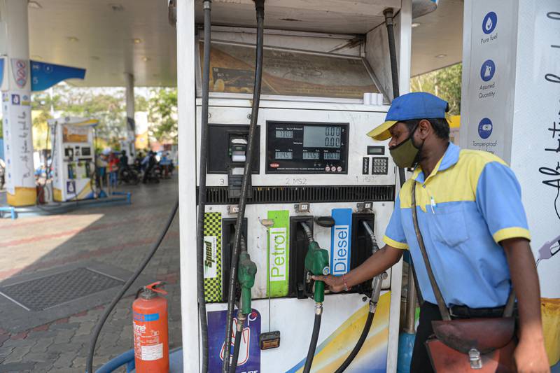A fuel station employee fills a car with petrol in Secunderabad, India. The country is vulnerable to fuel price increases since it is the world’s third-largest consumer of oil. AFP