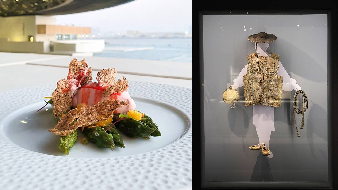The asparagus and black rice leaf appetiser from Fouquet's Abu Dhabi alongside a Joseon dynasty outfit on display in the Stories of Paper exhibition at Louvre Abu Dhabi. Photo: Fouquet's Abu Dhabi; Pawan Singh / The National 
