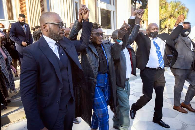 Wanda Cooper-Jones, the mother of murder victim Ahmaud Arbery, walks out of Glynn County Courthouse surrounded by supporters after a judge sentenced Greg McMichael, his son, Travis McMichael, and a neighbour, William Bryan, to life in prison in Brunswick, Georgia, for his murder. The three white men armed themselves, then chased and killed Arbery, who was black. AP