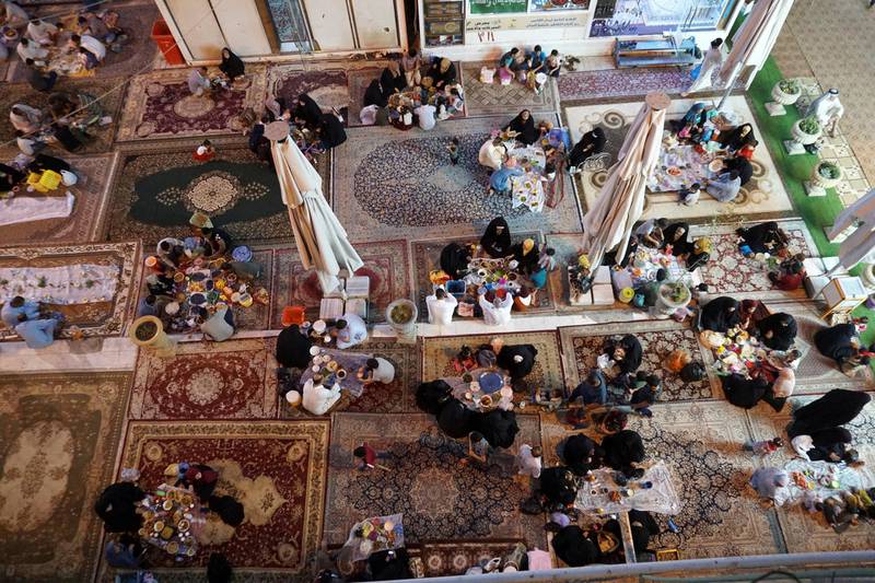 Iraqi families break their daily fast after staying away from food and water from sunrise to sunset during the month Ramadan, in Hilla, Iraq. Reuters