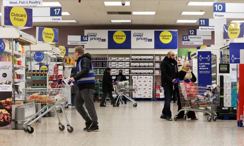 Shoppers in the UK are buying less and switching to cheaper brands, Tesco said, as the cost of living soars. REUTERS